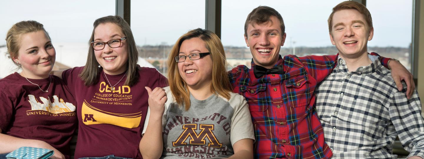 Five students sit together in a lounge at 17th Ave Residence Hall
